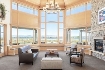 a living room with a fireplace and large windows